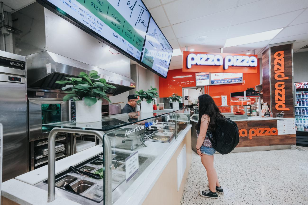 A student ordering food from Noodles