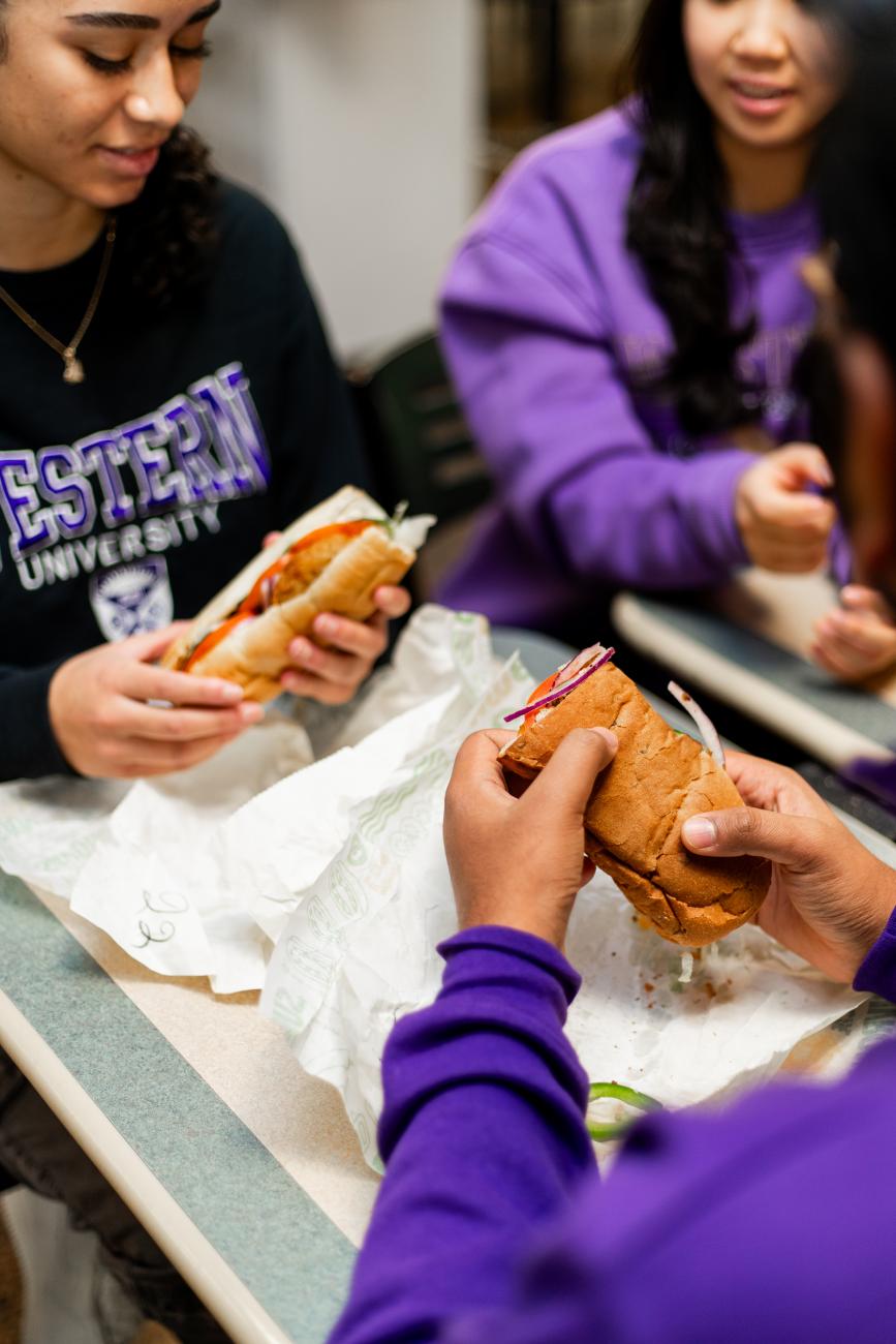 Students eating a sub