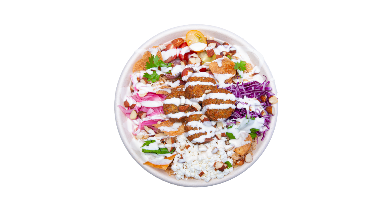 A photo of a finished bowl with falafel, dressing and toppings.