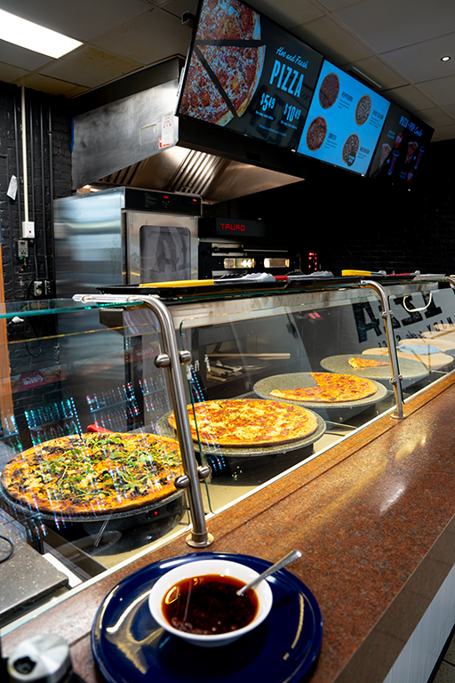 A row of pizzas cooling on the counter at the Pizza eatery in UCC Food Hub.