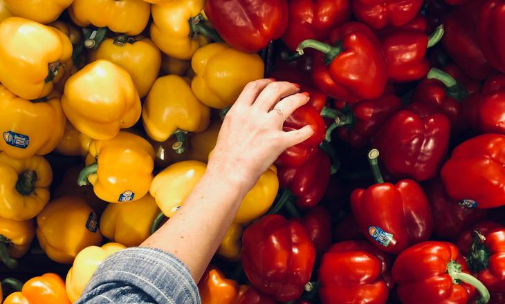 hand grabbing pepper